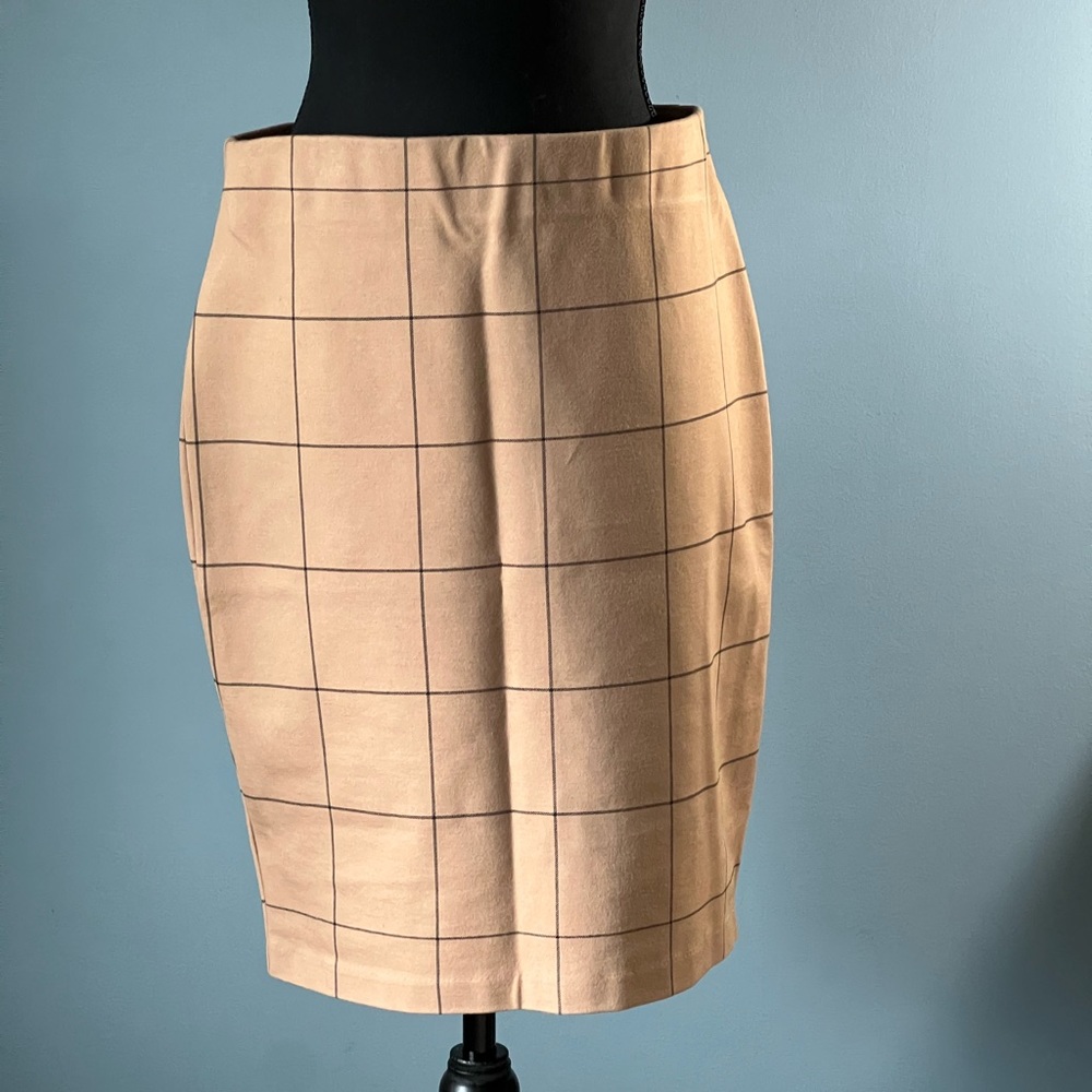 Stretchy pencil skirt tan with black plaid design. Size 8 new without tags.